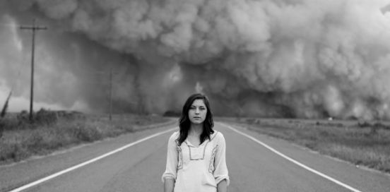woman standing in front of a storm