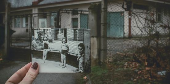 old photo of girls by a fence