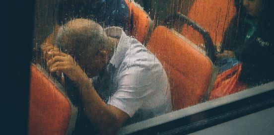 man in a bus on a rainy day