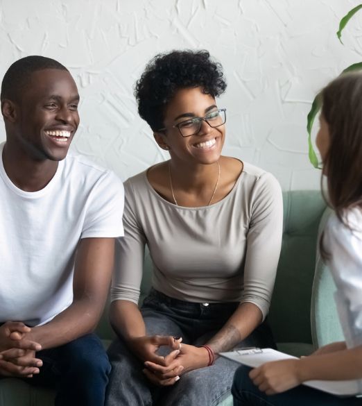 happy couple speaking with therapists