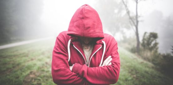 person with hood over their face