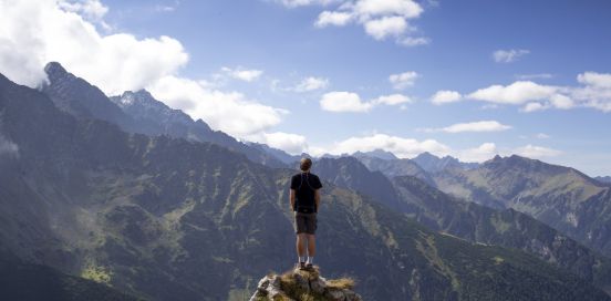 man standing on top of a rock
