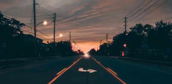 sun setting on the road