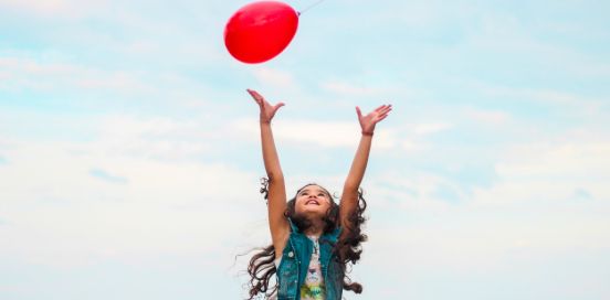 girl playing with balloon