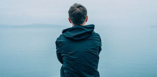 man standing by water