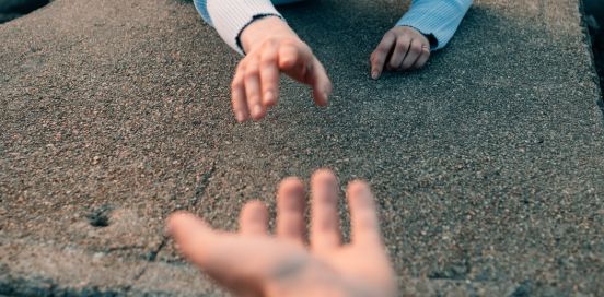 two hands reaching for each other