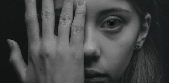 covering half her face