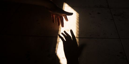 two hands in shadows