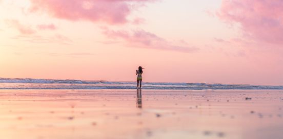 woman standing alone on a beach