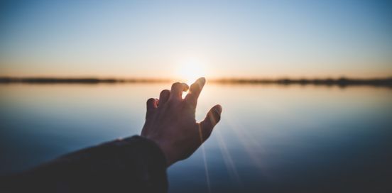 hand reaching to the sun