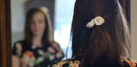 looking into her reflection