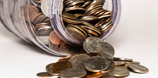 coins coming out of jar