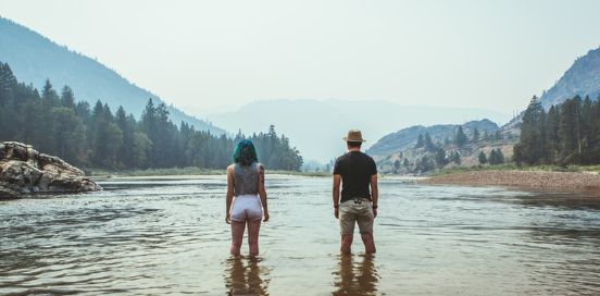 two people standing in a lake