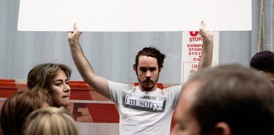 Man with a shirt that says 'I'm sorry'