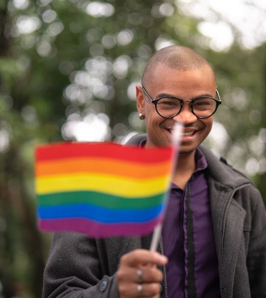 Smiling with an rainbow flag