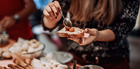 woman preparing toast and cream cheese