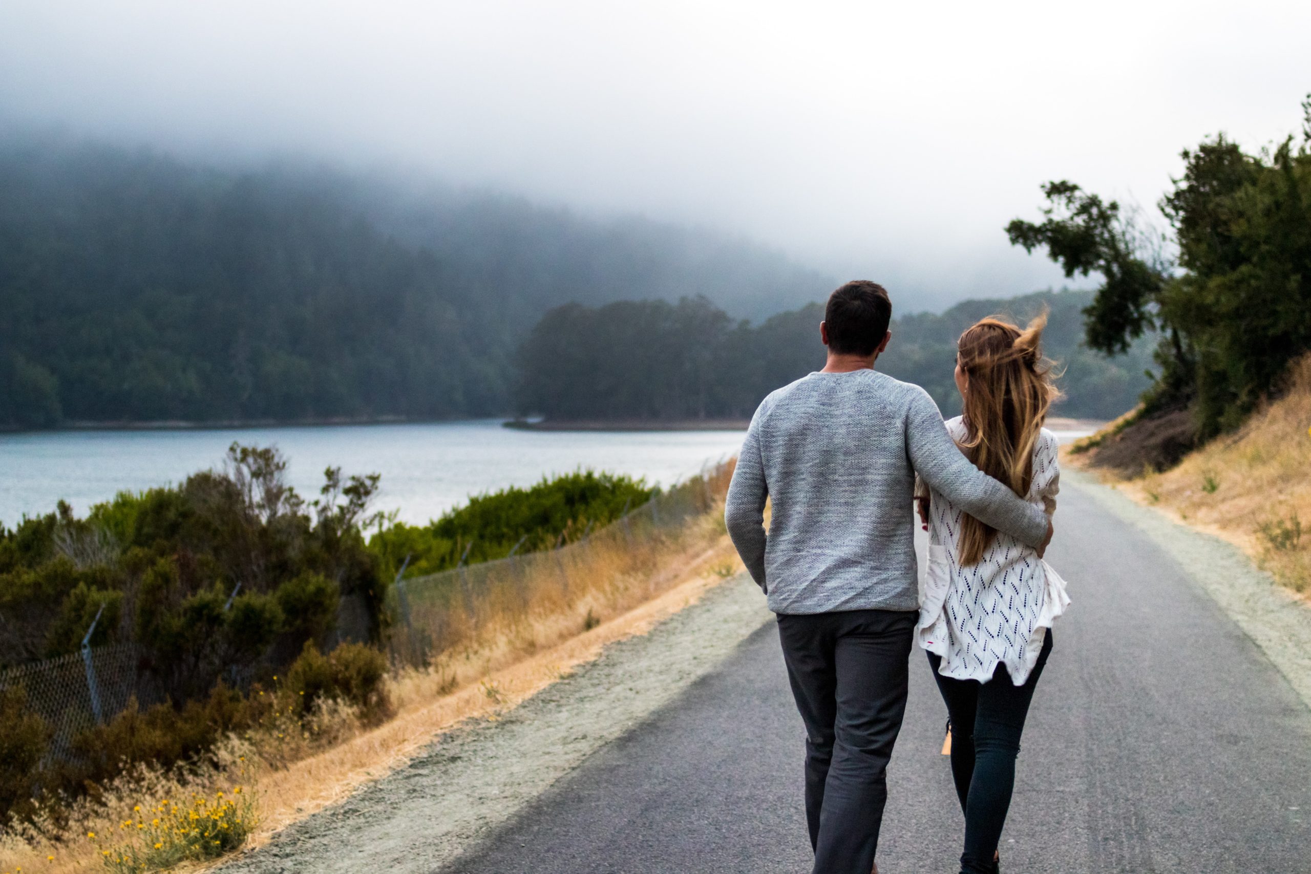 couple walking along a lake