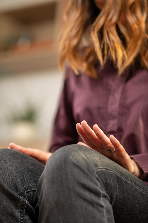 Person practicing EMDR knee tapping technique during a therapy session