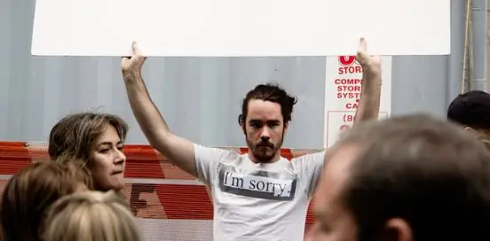 Man with a shirt that says 'I'm sorry'